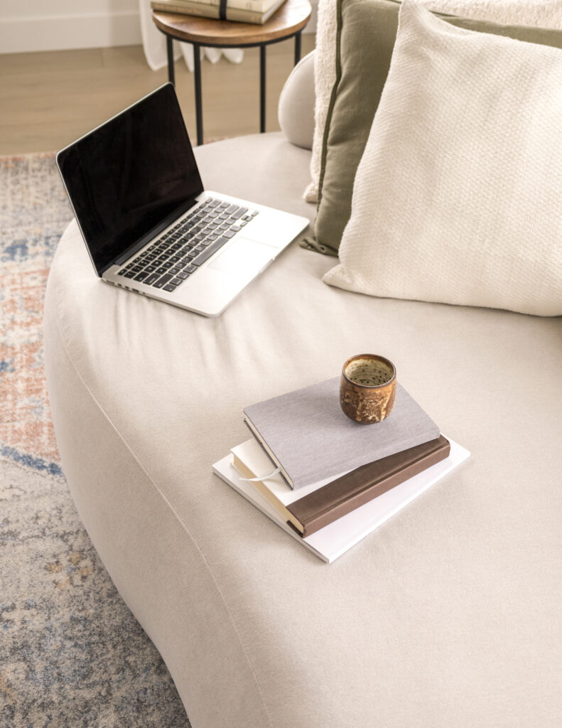 laptop and books on couch for blogging at home: what is content strategy