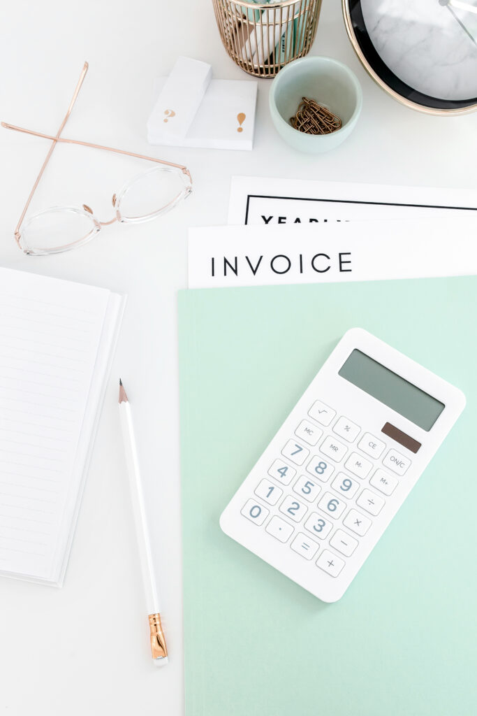 invoice for blogging services on desk with glasses and calculator