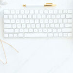 tools for blogging like a keyboard, notebook, glasses