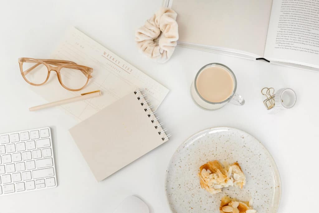 blogging supplies like notepad, keyboard, snack and coffee
