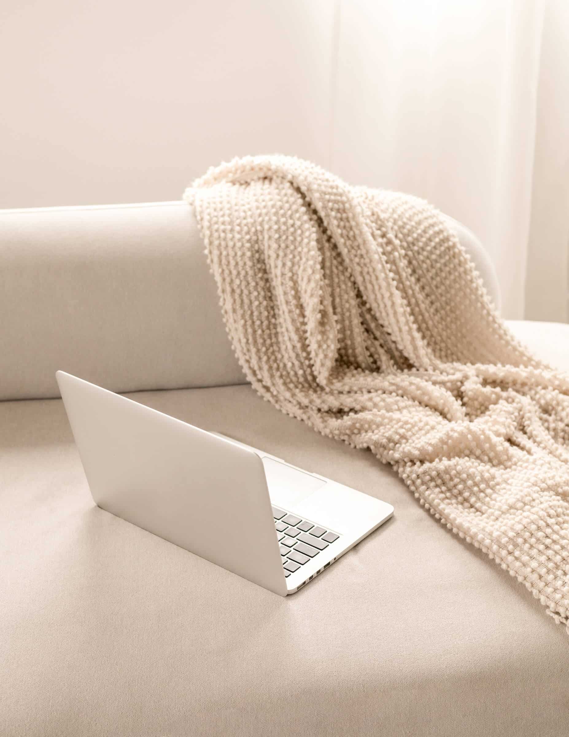computer on couch for researching what is content strategy